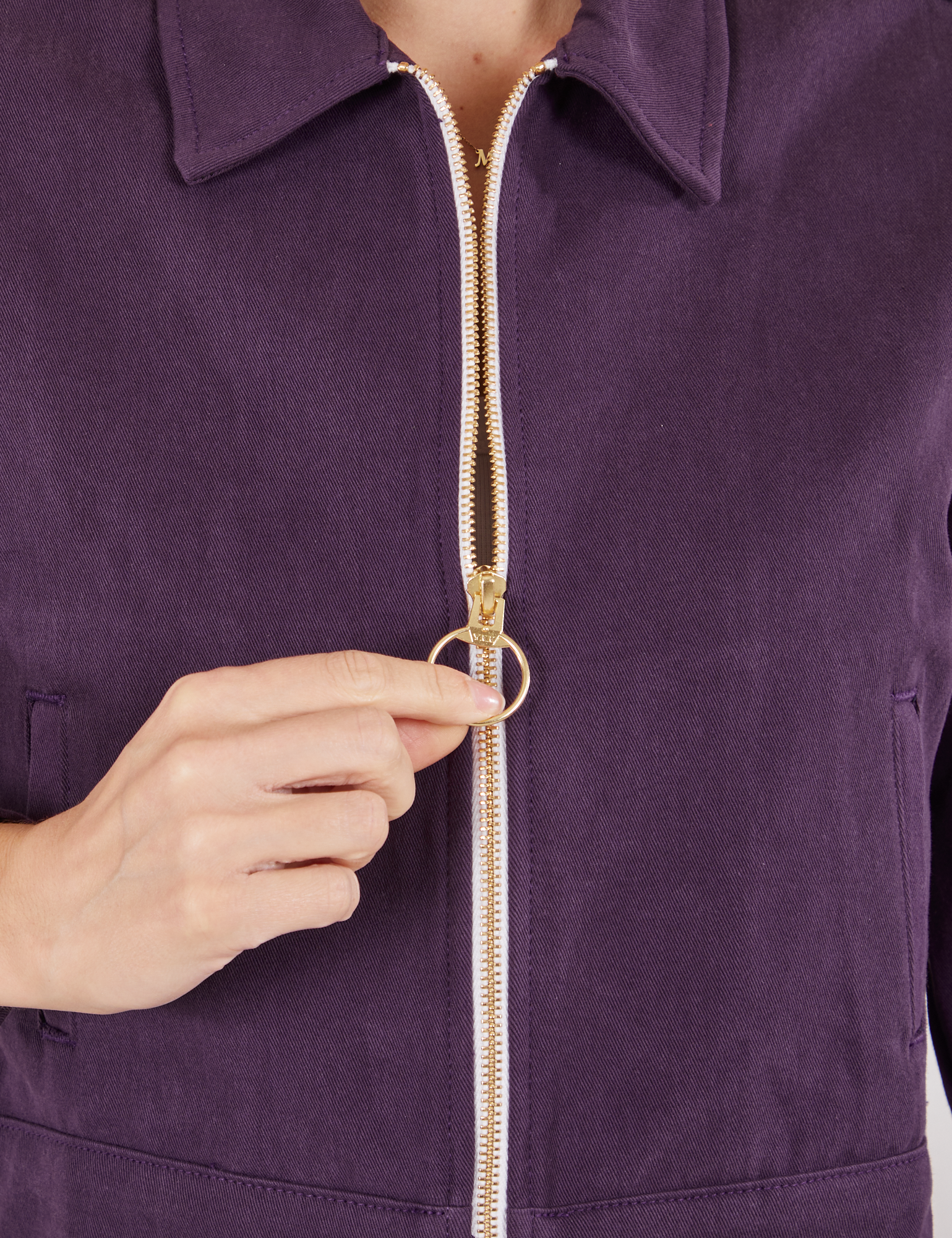 Ricky Jacket in Nebula Purple front close up. Madeline is holding onto the brass zipper pull