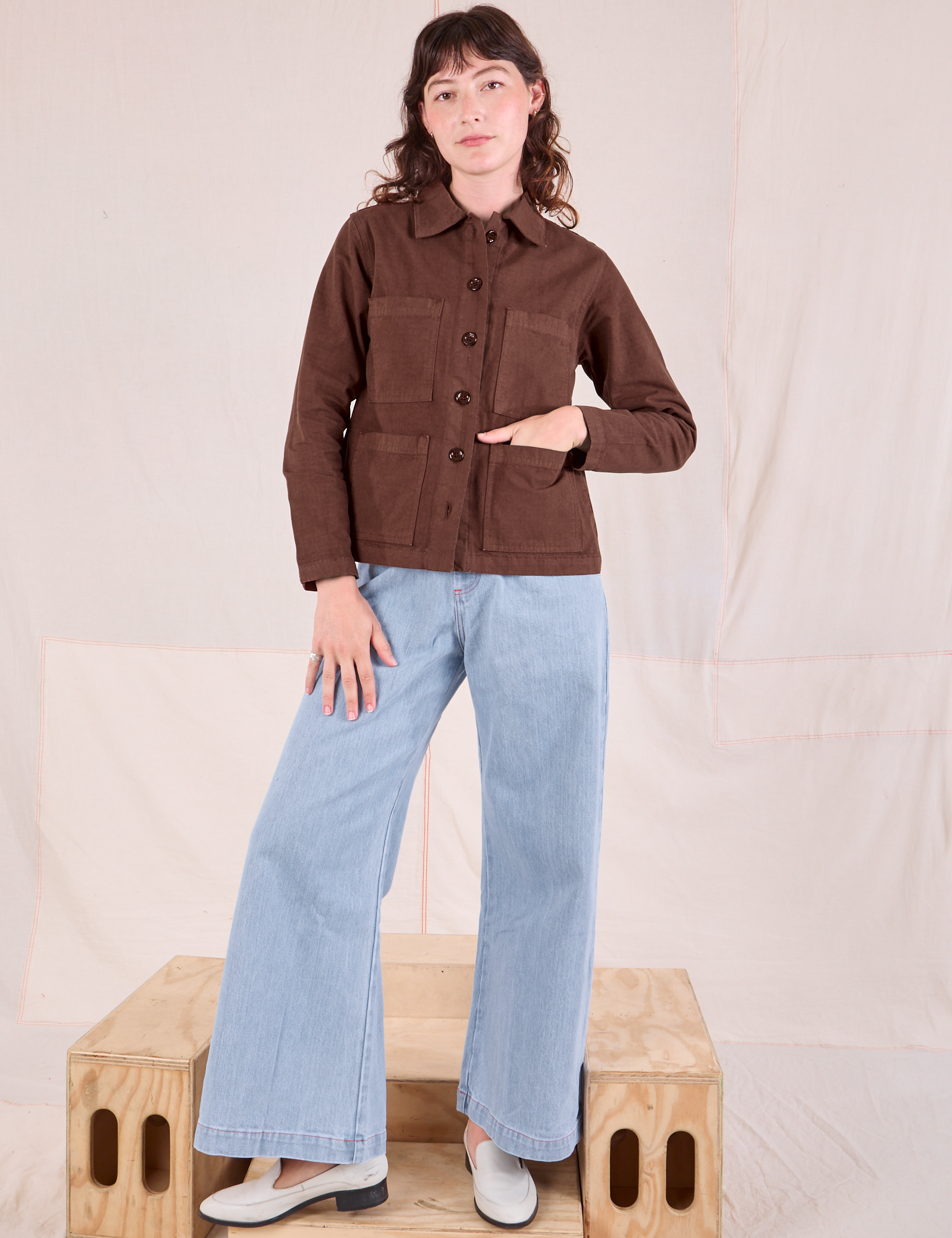 Alex is wearing Ripstop Work Jacket in Fudgesicle Brown and Wide Leg Denim Jeans in Lightwash