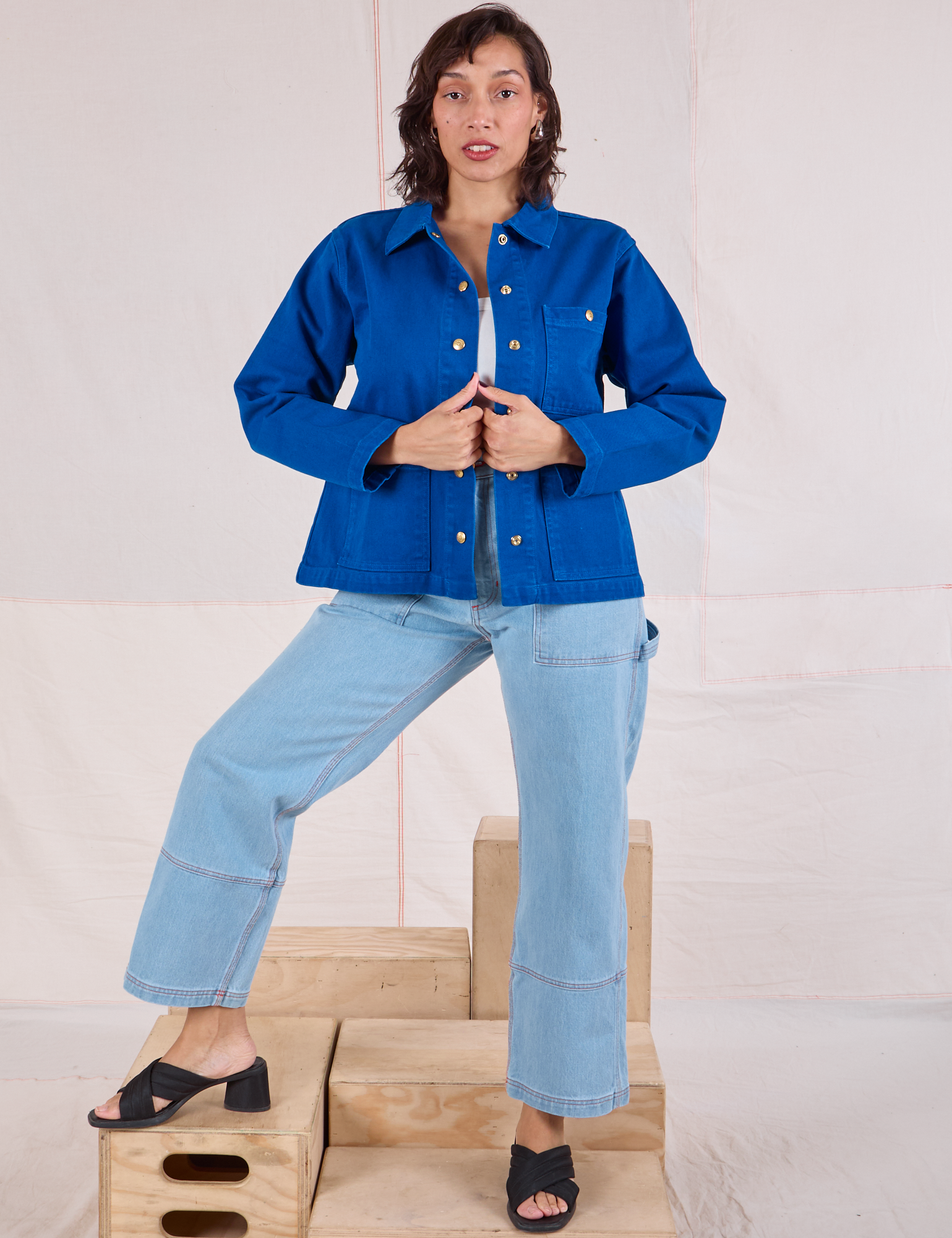 Tiara is wearing Denim Work Jacket in Royal Blue paired with light wash Carpenter Jeans