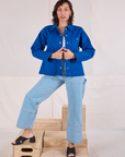 Tiara is wearing Denim Work Jacket in Royal Blue paired with light wash Carpenter Jeans