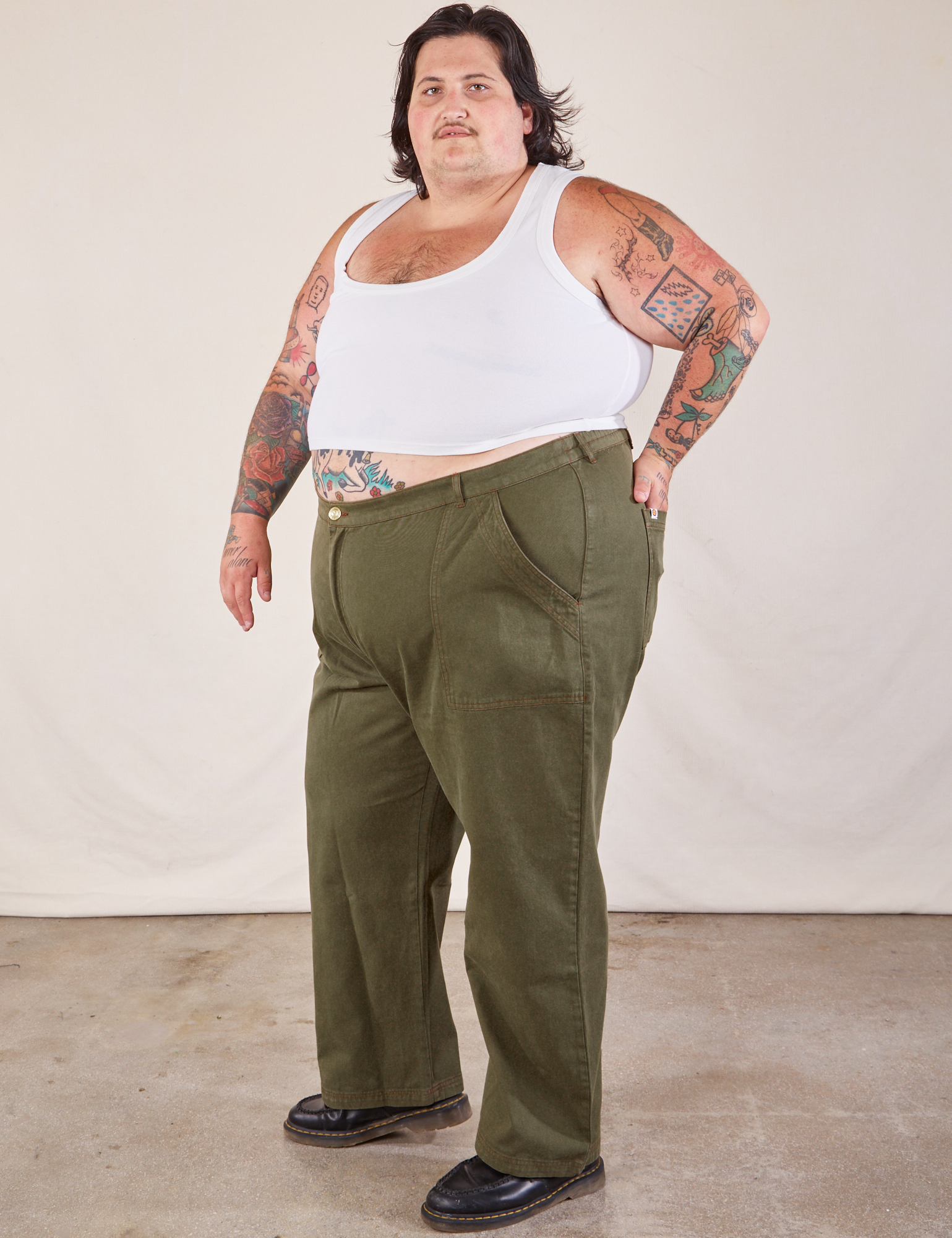 Angled front view of Work Pants in Surplus Green and Cropped Tank in vintage tee off-white on Sam