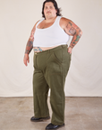 Angled front view of Work Pants in Surplus Green and Cropped Tank in vintage tee off-white on Sam