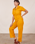 Side view of Short Sleeve Jumpsuit in Mustard Yellow worn by Tiara