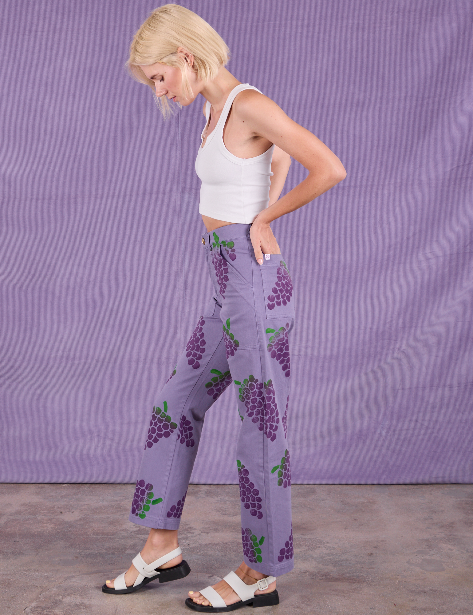 Side view of Paintstamped Work Pants in Grape and Cropped Tank in Vintage Tee Off-White on Madeline