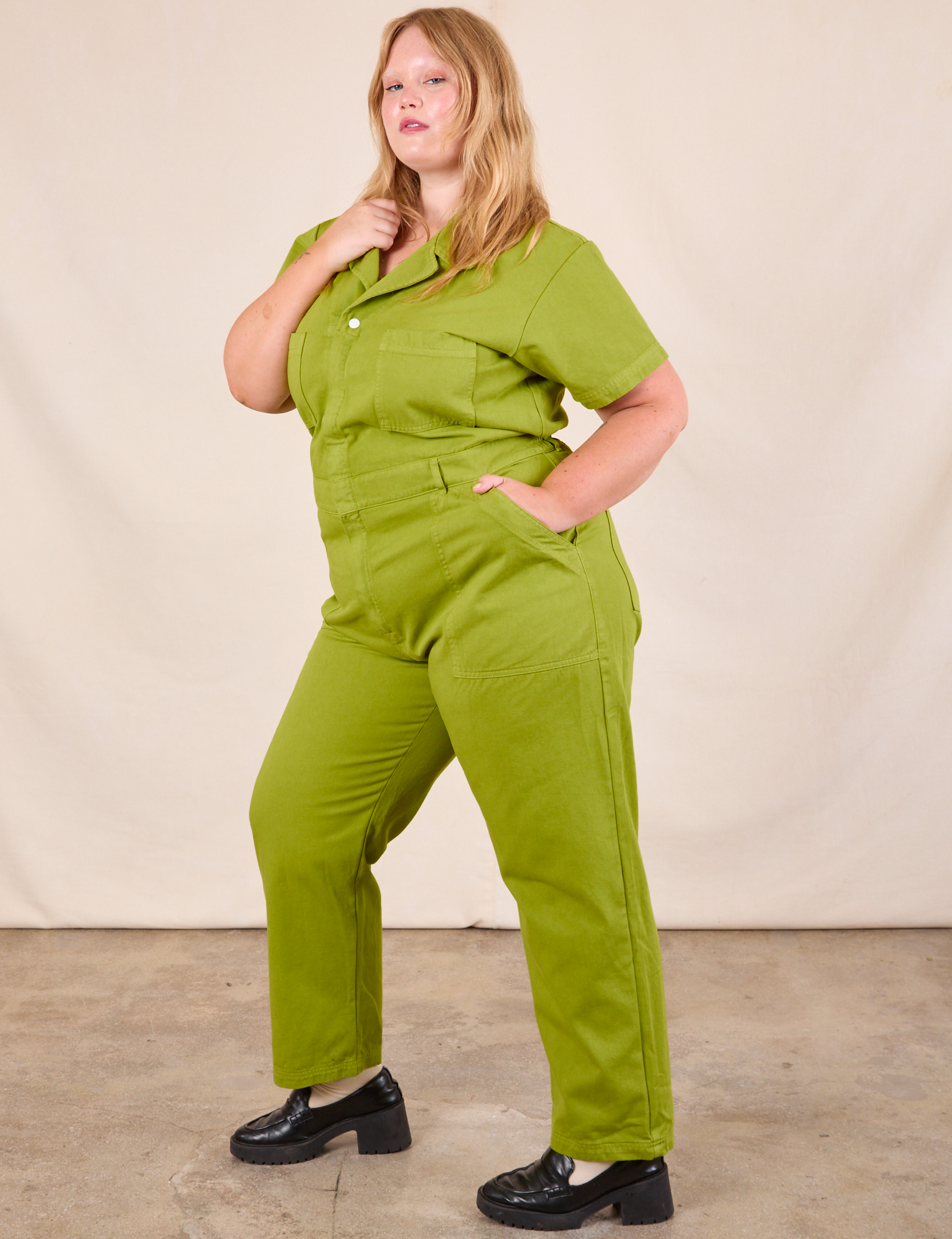 Juliet is wearing Short Sleeve Jumpsuit in Gross Green