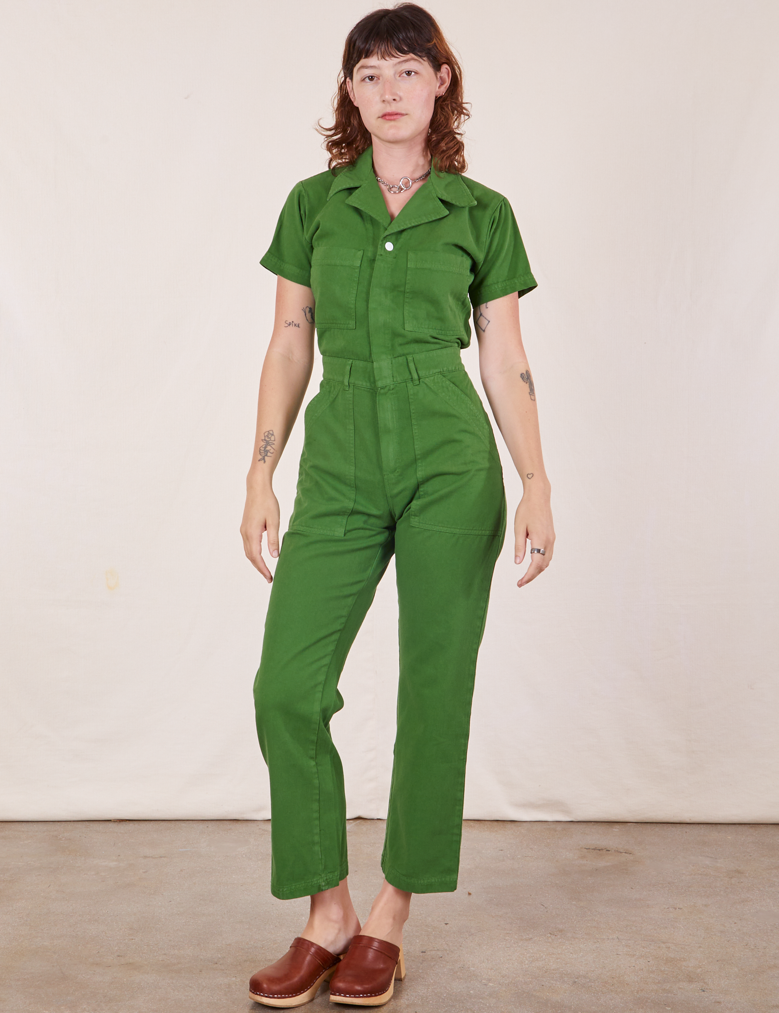 Alex is 5&#39;8&quot; and wearing XS Short Sleeve Jumpsuit in Lawn Green