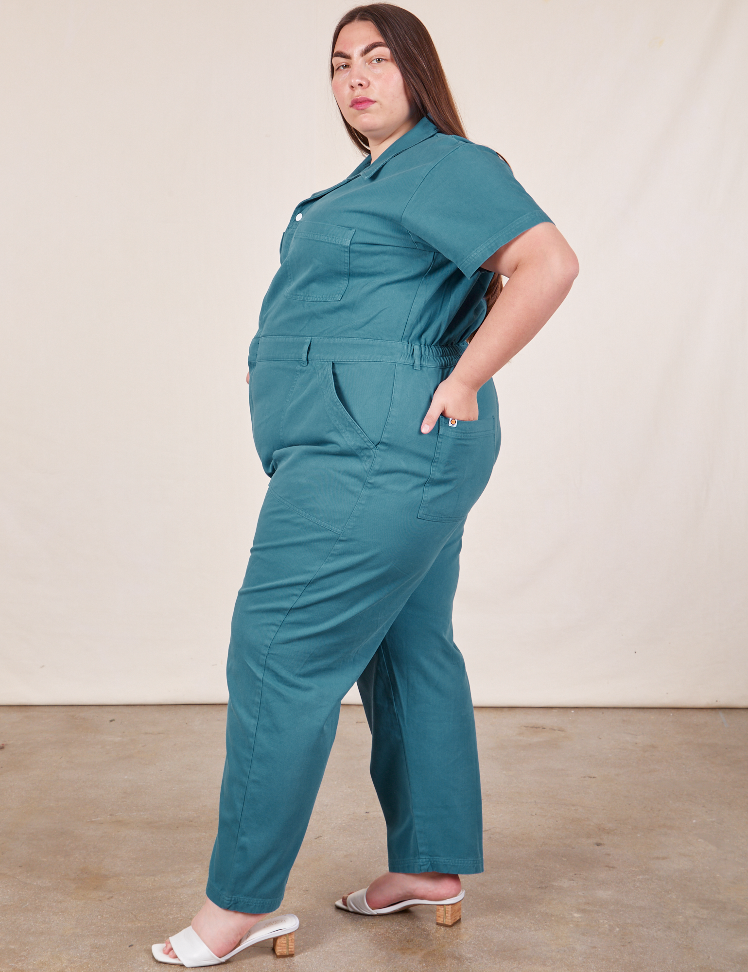 Side view of Short Sleeve Jumpsuit in Marine Blue worn by Marielena