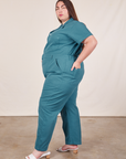 Side view of Short Sleeve Jumpsuit in Marine Blue worn by Marielena