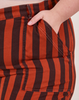 Black Striped Work Pants in Paprika front pocket close up. Marielena has her hand in the pocket.