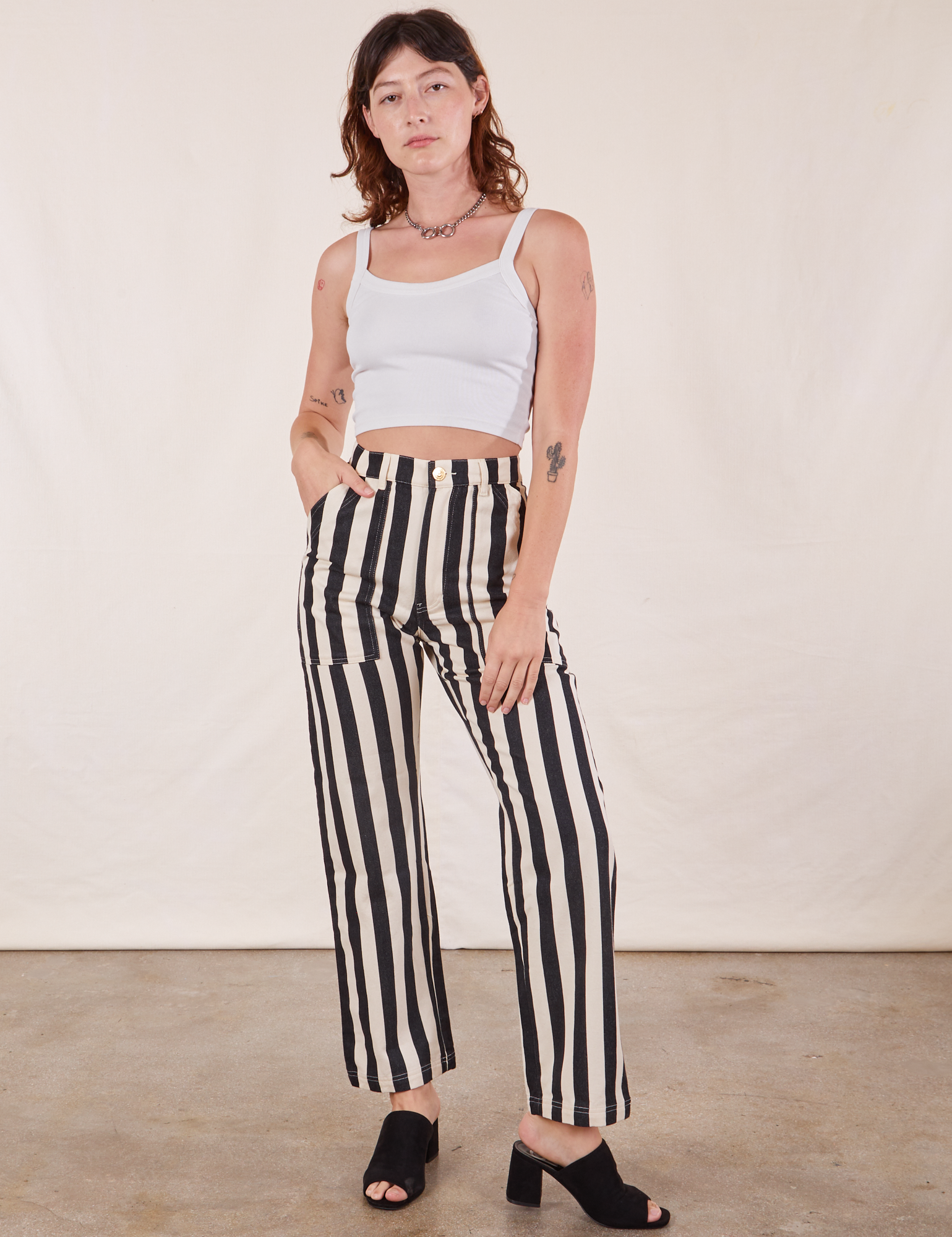Alex is 5&#39;8&quot; and wearing XS Black Striped Work Pants in White paired with vintage off-white Cropped Cami