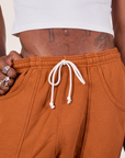 Cropped Rolled Cuff Sweatpants in Burnt Terracotta front close up on Jerrod