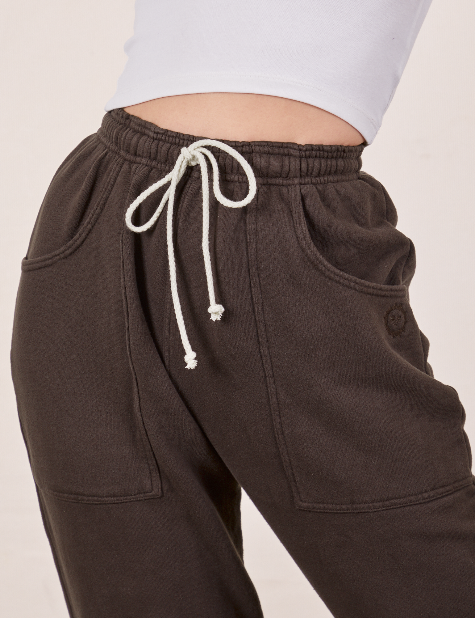 Cropped Rolled Cuff Sweatpants in Espresso Brown front close up on Alex
