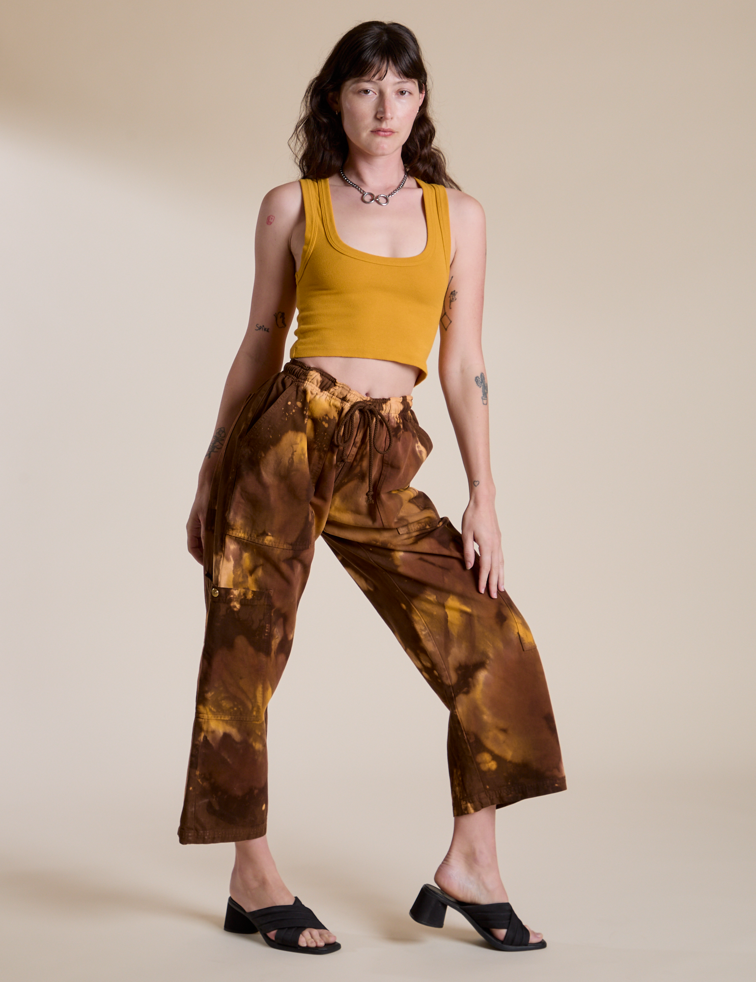 Alex is wearing Magic Waters Drop Pocket Pants in Honey Brown and mustard yellow Cropped Tank