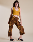 Alex is wearing Magic Waters Drop Pocket Pants in Honey Brown and mustard yellow Cropped Tank
