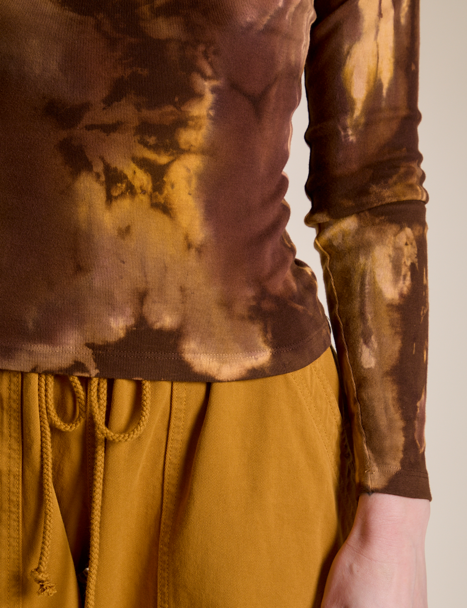 Close up of Long Sleeve Baby Tee in Honey Brown on Alex