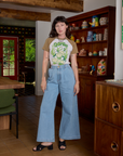 Alex is wearing Short Sleeve Raglan Tee in Garlic tucked into light wash Indigo Wide Leg Trousers