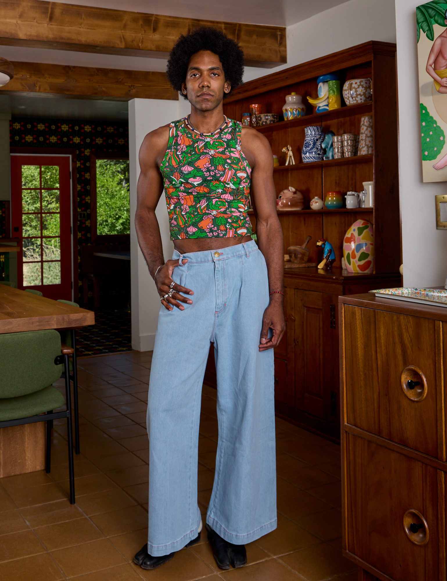 Jerrod is wearing Kitchen Collection Racerback Tank and light wash Indigo Wide Leg Trousers