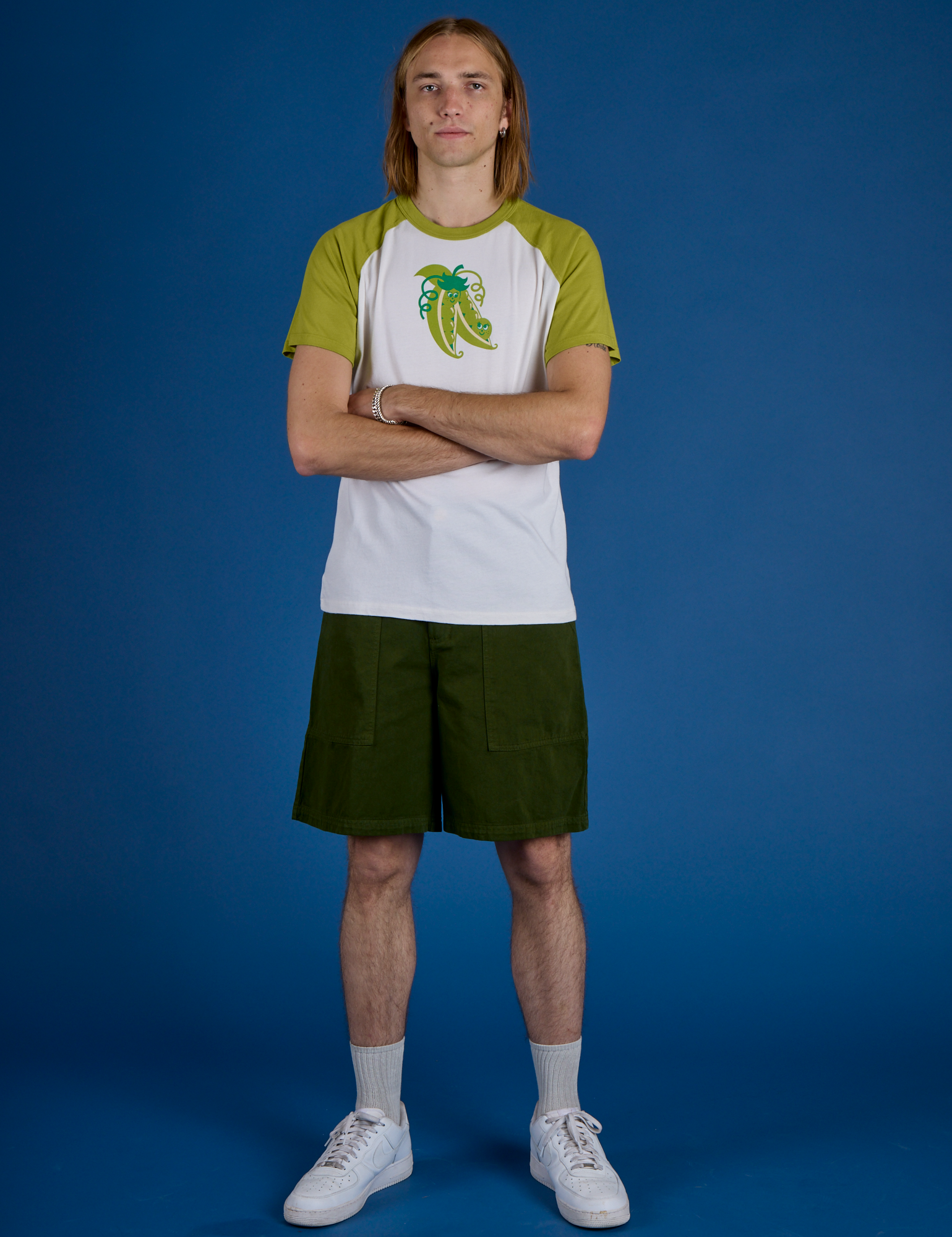 Grant is wearing Produce Raglan Tee in Snap Peas
