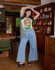 Alex is wearing Short Sleeve Raglan Tee in Veggies tucked into light wash Indigo Wide Leg Trousers