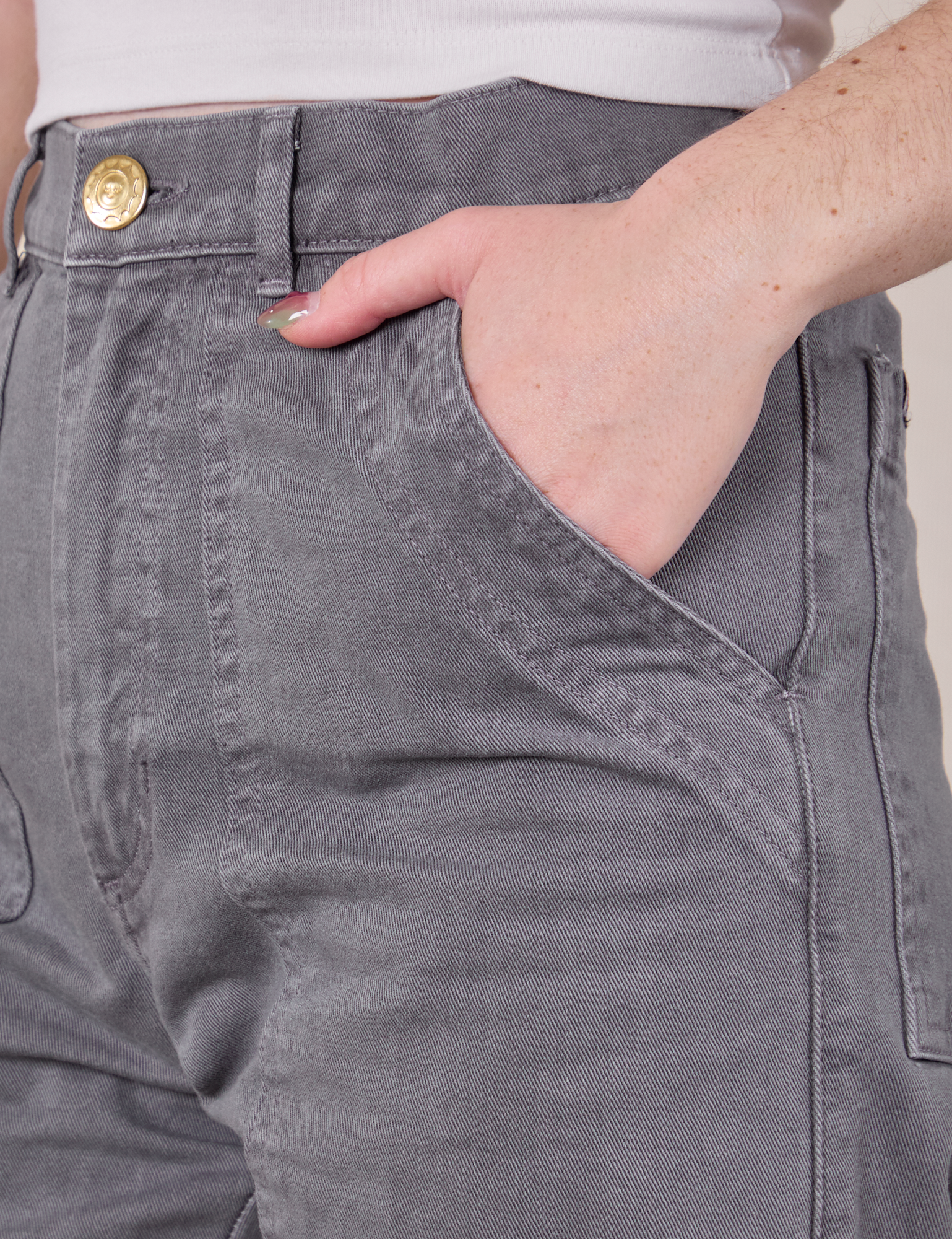 Close up of Hana&#39;s hand in the front pocket of Work Pants in Washed Grey