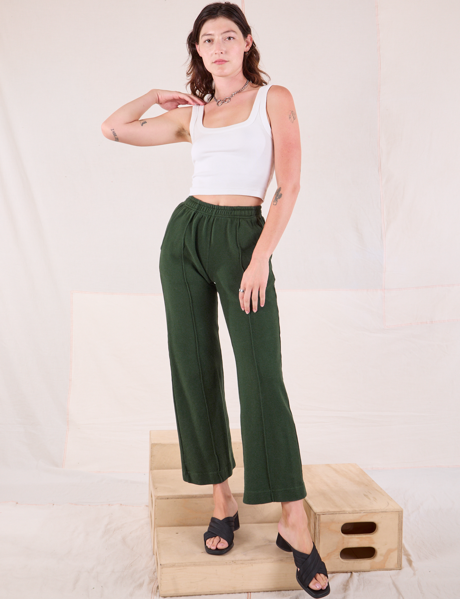 Alex is wearing Easy Western Pants in Swamp Green