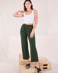 Alex is wearing Easy Western Pants in Swamp Green