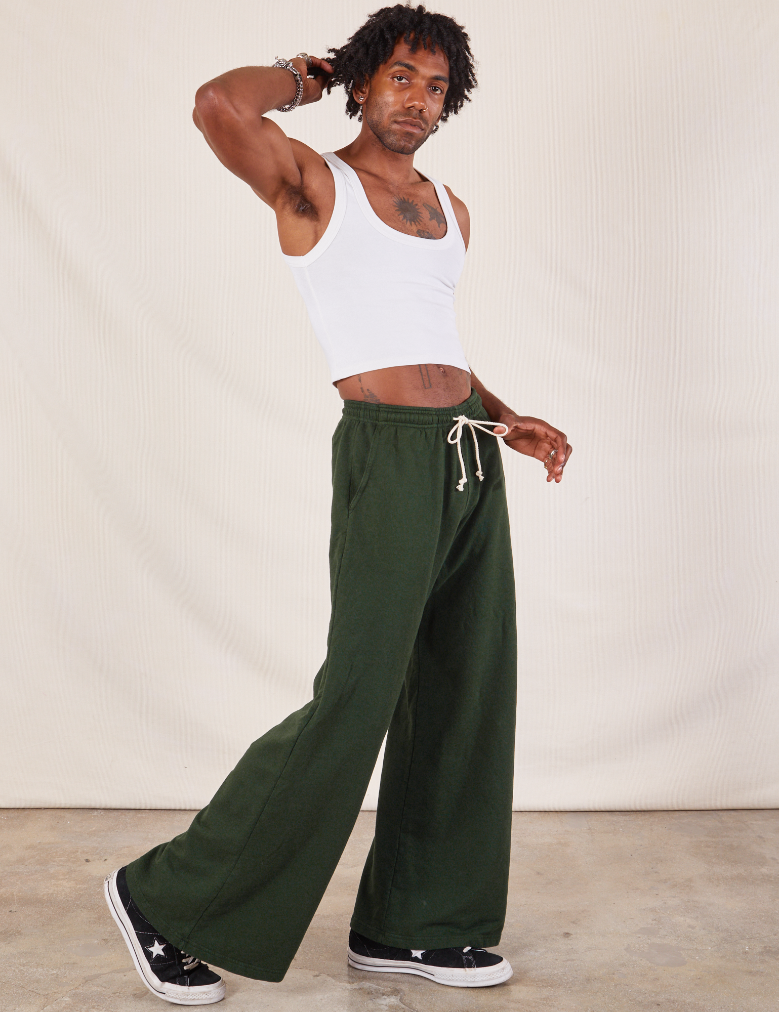 Side view of Wide Leg Sweat Pants in Swamp Green and Cropped Tank in vintage tee off-white on Jerrod