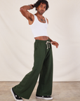 Side view of Wide Leg Sweat Pants in Swamp Green and Cropped Tank in vintage tee off-white on Jerrod