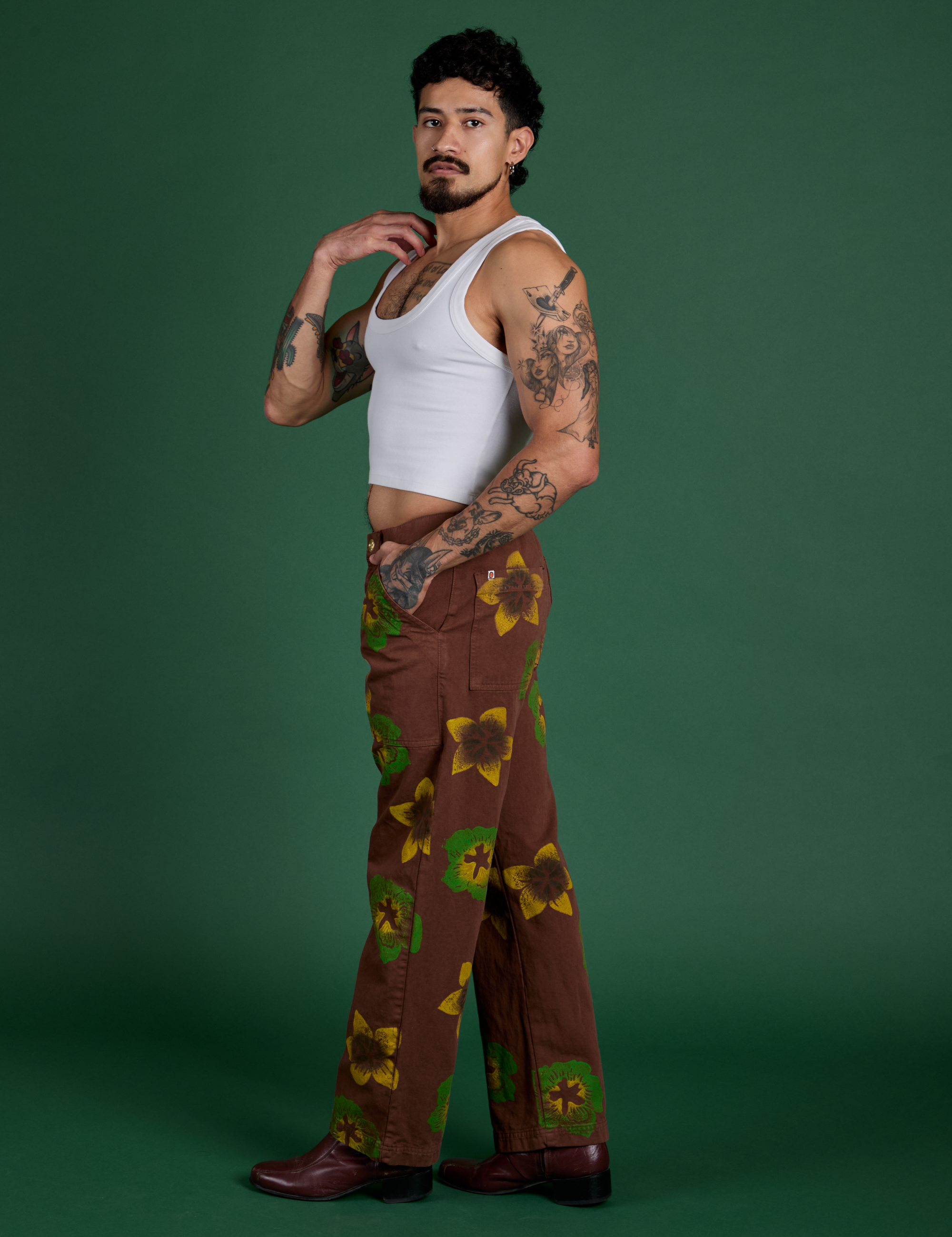 Side view of Floral Painted Work Pants in Brown and Cropped Tank in Vintage Tee White on Jesse
