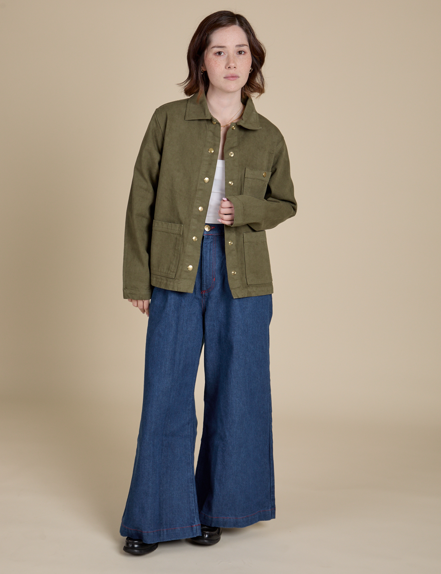 Hana is wearing Denim Work Jacket in Surplus Green and dark wash Indigo Wide Leg Trousers