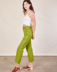 Side view of Work Pants in Gross Green and Cropped Tank in vintage tee off-white on Alex