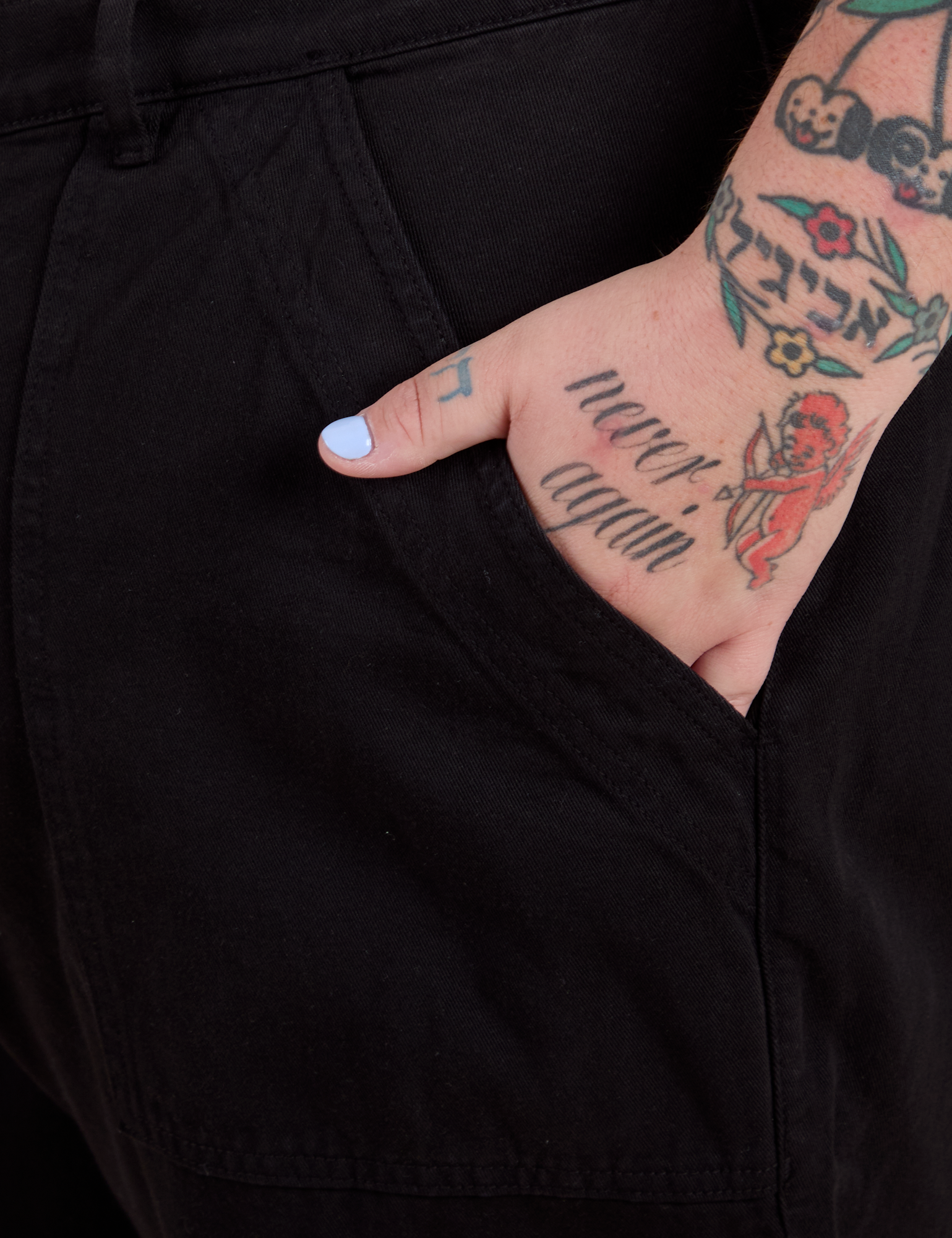 Close up of Sam's hand in the front pocket of Work Pants in Basic Black