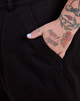 Close up of Sam's hand in the front pocket of Work Pants in Basic Black