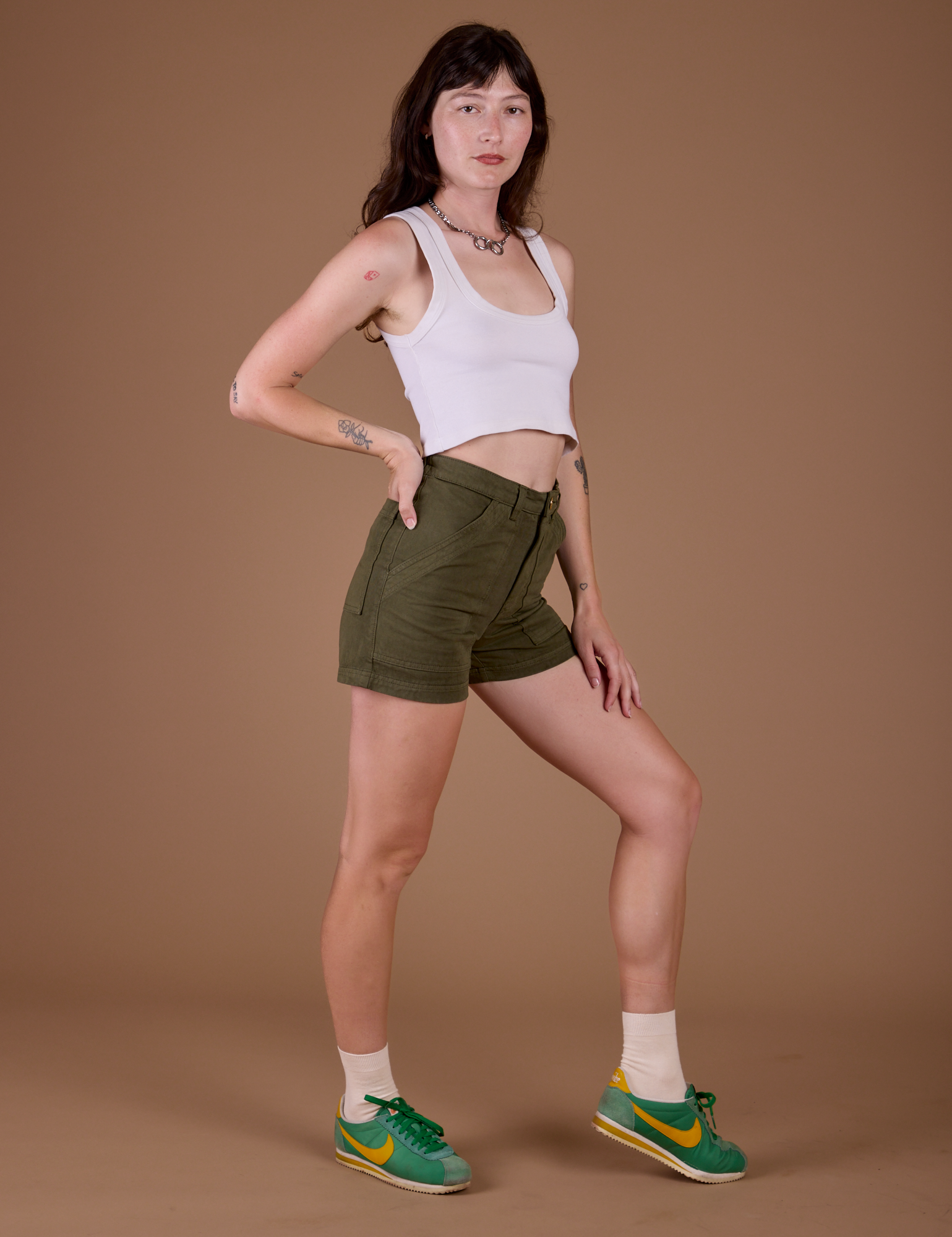 Side view of Classic Work Shorts in Surplus Green and vintage off white Cropped Tank on Alex
