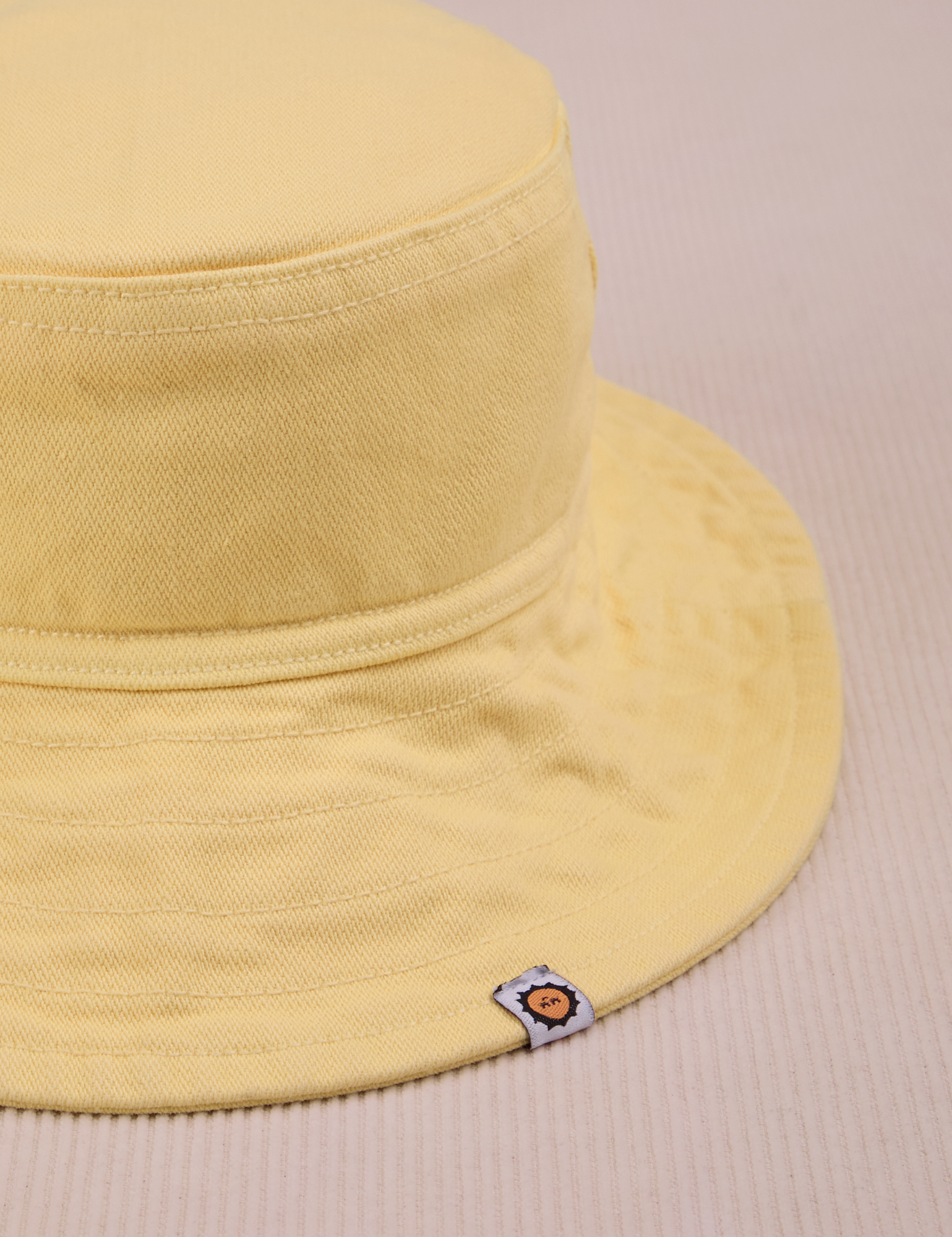 Wide Brim Denim Bucket Hat in Butter Yellow close up