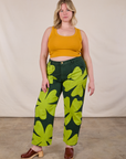 Lish is wearing Paintstamped Clover Work Pant and Mustard Yellow Cropped Tank