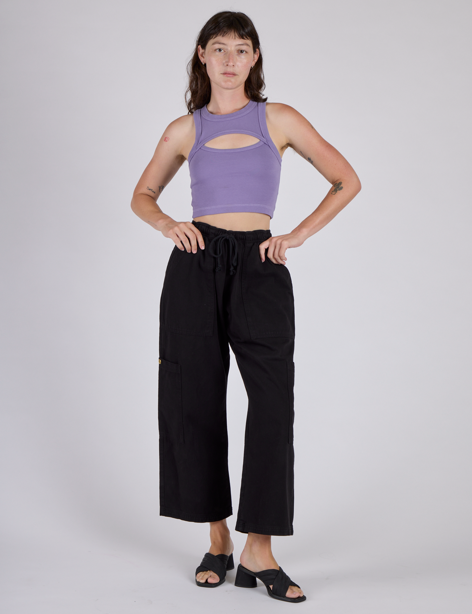 Alex is wearing the Faded Grape Porthole Tank and Black Cargo Drop Pocket Pants