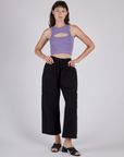 Alex is wearing the Faded Grape Porthole Tank and Black Cargo Drop Pocket Pants