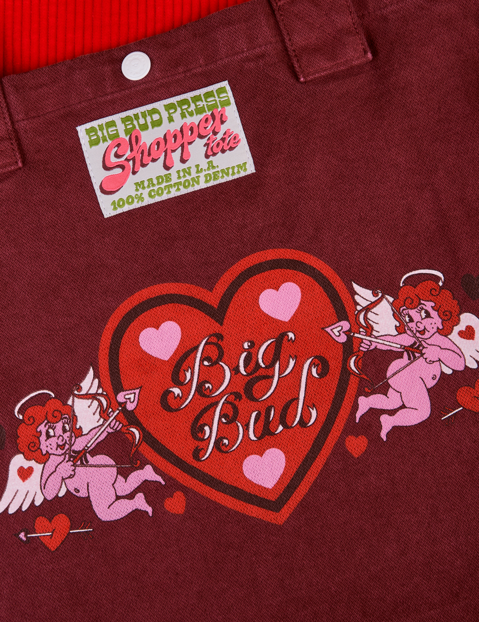 Love Big Bud Shopper Tote close up. Red heart with Big Bud text and two pink cupids on each side