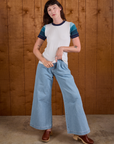 Alex is wearing Calypso Tee in Ocean and light wash Indigo Wide Leg Trousers