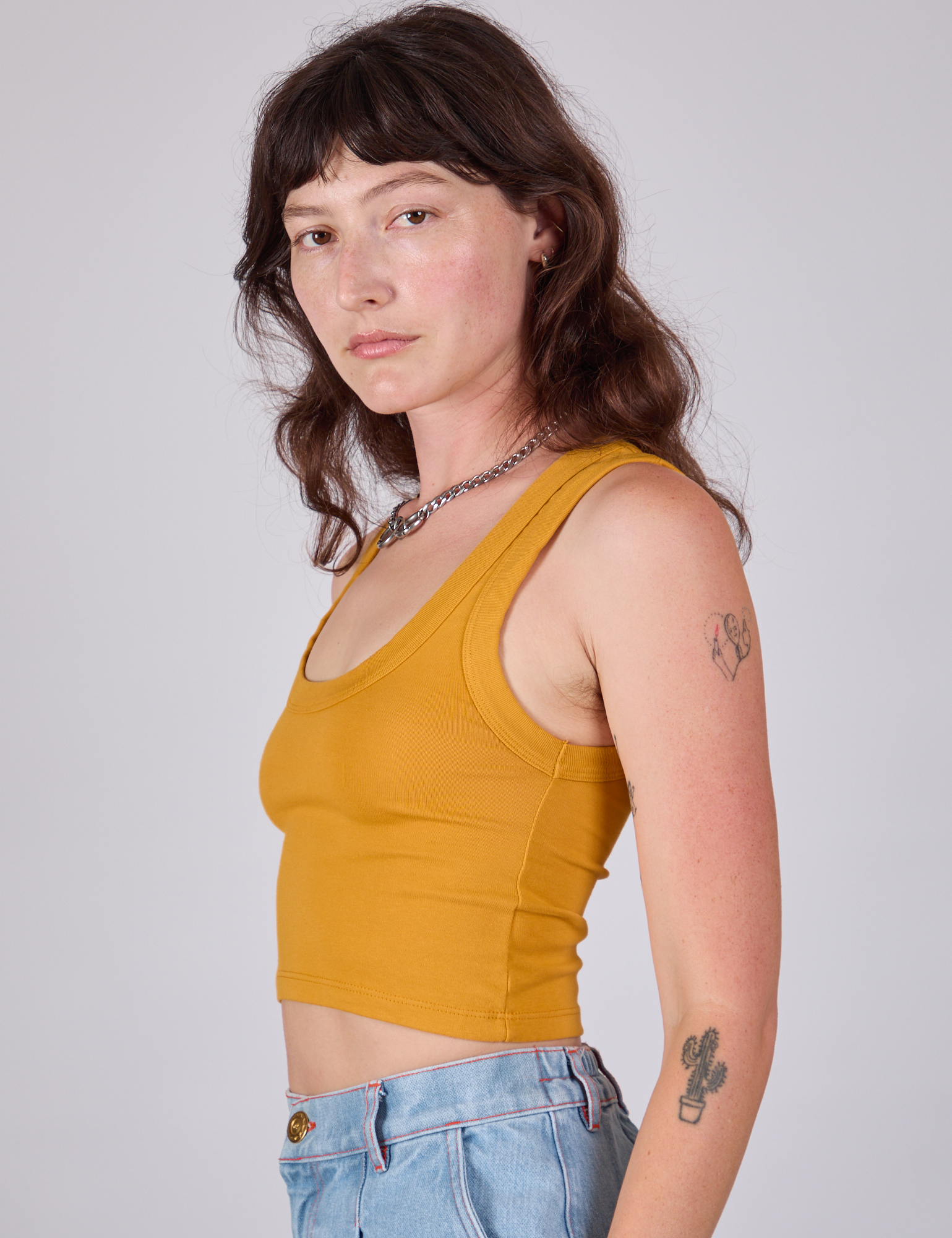 Cropped Tank Top in Mustard Yellow side view on Alex