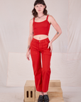 Alex is wearing mustang red Mid-Rise Work Pants in Mustang Red and Cropped Cami