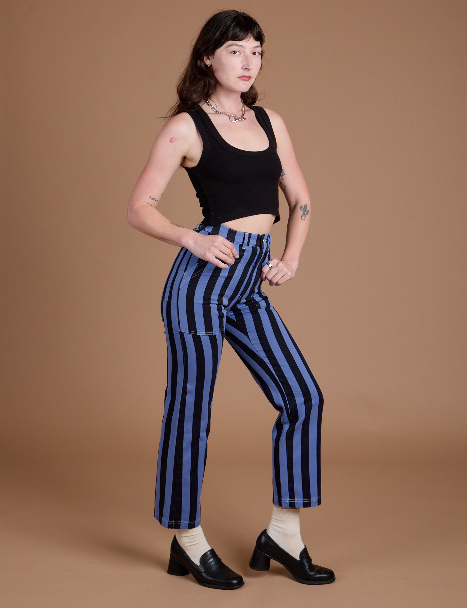 Angled front view of Black Stripe Work Pants in Cornflower Blue and black Cropped Tank on Alex