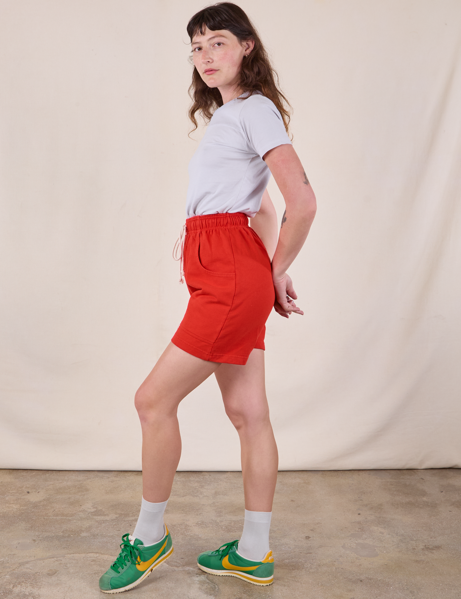 Side view of Sweat Shorts in Mustang Red and Jr. Varsity Tee in Stone White