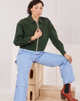 Tiara is wearing Ricky Jacket in Swamp Green and light wash Carpenter Jeans