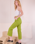 Side view of Action Pants in Gross Green and Cropped Tank in Vintage Tee Off-White on Margaret