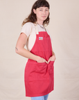 Angled view of Full Denim Apron in Hot Pink worn by Alex