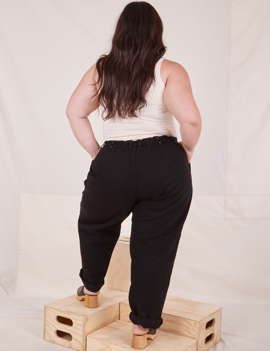 Back view of Denim Trouser Jeans in Black and vintage off-white Tank Top worn by Ashley