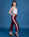 Side view of Painted Action Pants in Red Wine and vintage tee white Cropped Tank on Alex