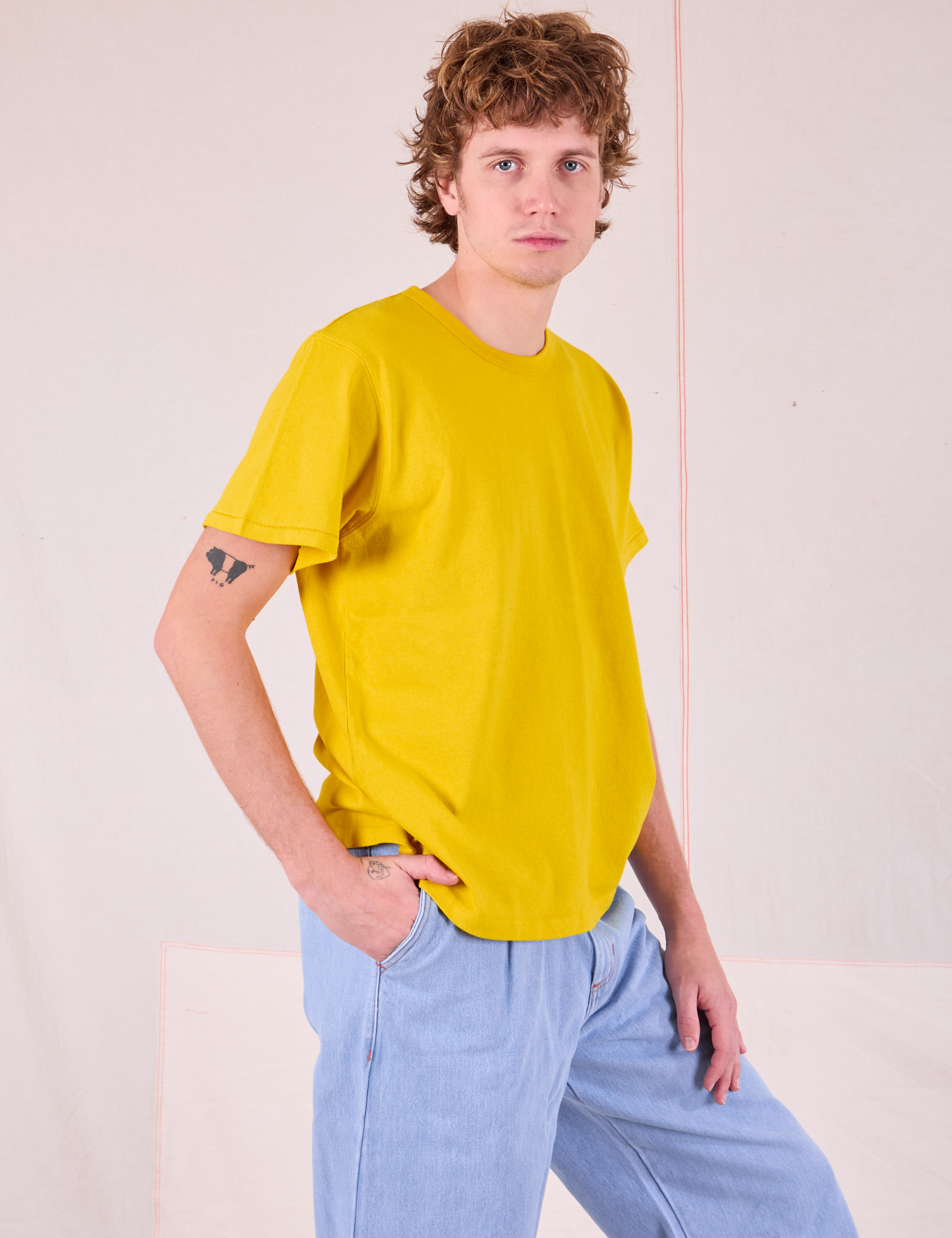 Burly Tee in Golden Yellow side view on Quinn